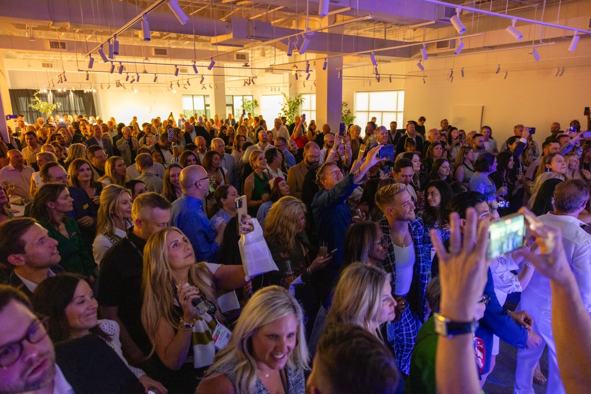 The crowd sings along and dances to the live music provided by Nile Rodgers & CHIC in the Bernhardt showroom.